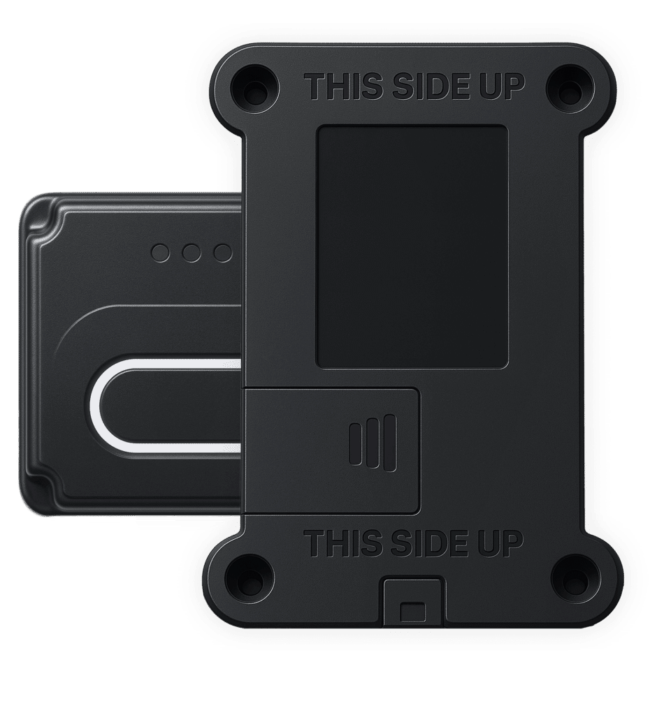 A picture showing two GPS tracking device pieces with the phrase “this side up” engraved on them.